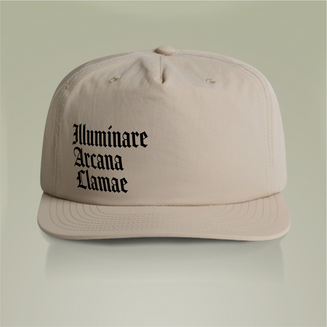 khaki Illuminare Arcana Lamae Surf Cap with embroidered white llama logo and intricate 'Illuminare Arcana Lamae' lettering, made from 100% recycled nylon with a plastic snapback closure.